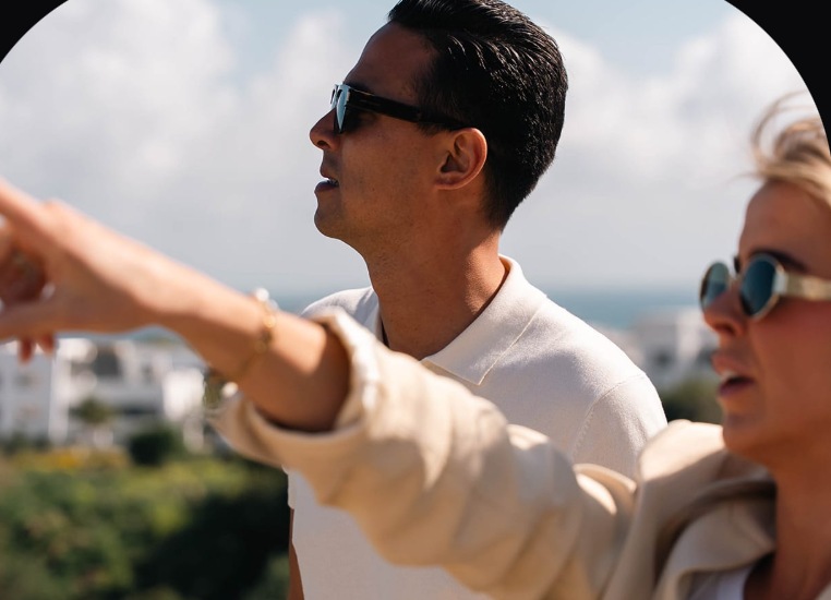 Cooiman specialist pointing out a Costa del Sol view to a client